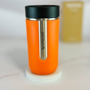 نمای کلی تراول ماگ نسپرسو نارنجی Nespresso nomad با بدنه استیل و طراحی شیک سوئیسی